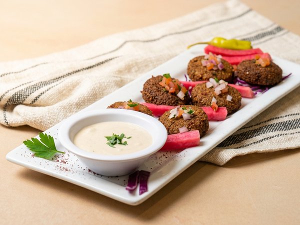 Golden crispy falafel balls on a plate at Phoenician Garden Fresno