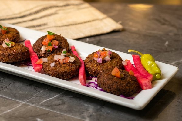 Close-up of falafel showing herb-packed interior at Phoenician Garden Fresno