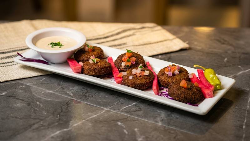 Hand-rolled falafel fried golden and served with tahini, a hot mezza plate at Phoenician Garden in Fresno
