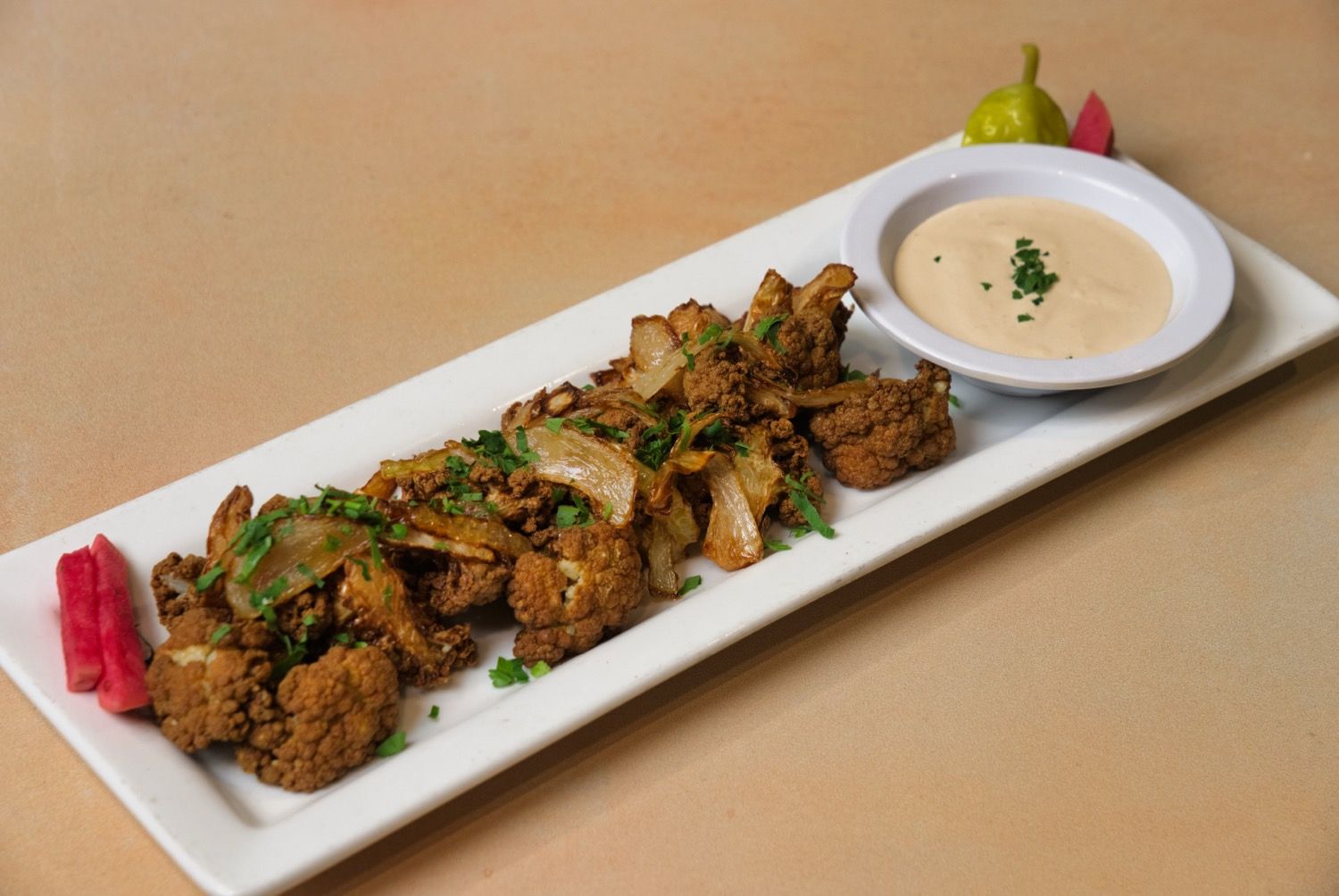 Fried cauliflower with caramelized onions and tahini at Phoenician Garden Fresno
