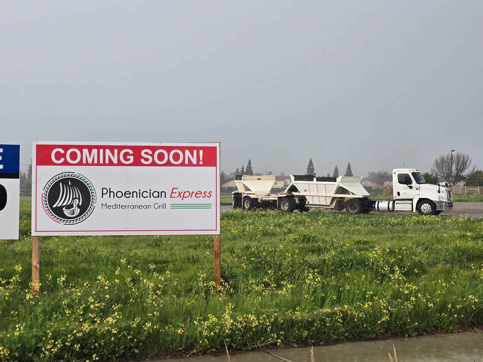 Phoenician Express Coming Soon sign on the Clovis construction lot at 2605 Owens Mountain Pkwy, with staged construction equipment