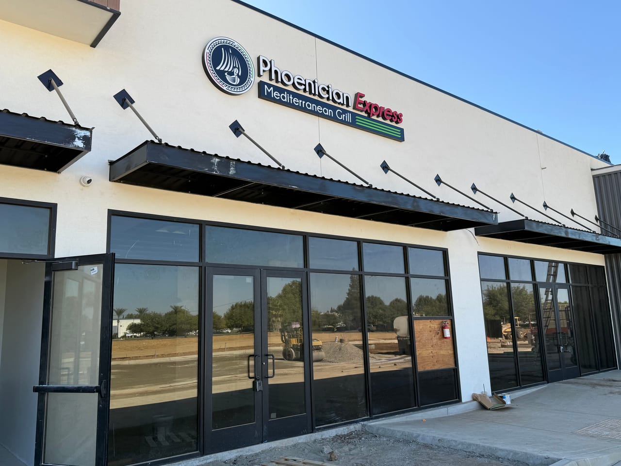 The new Phoenician Express storefront in Clovis with its sign installed, construction still under way