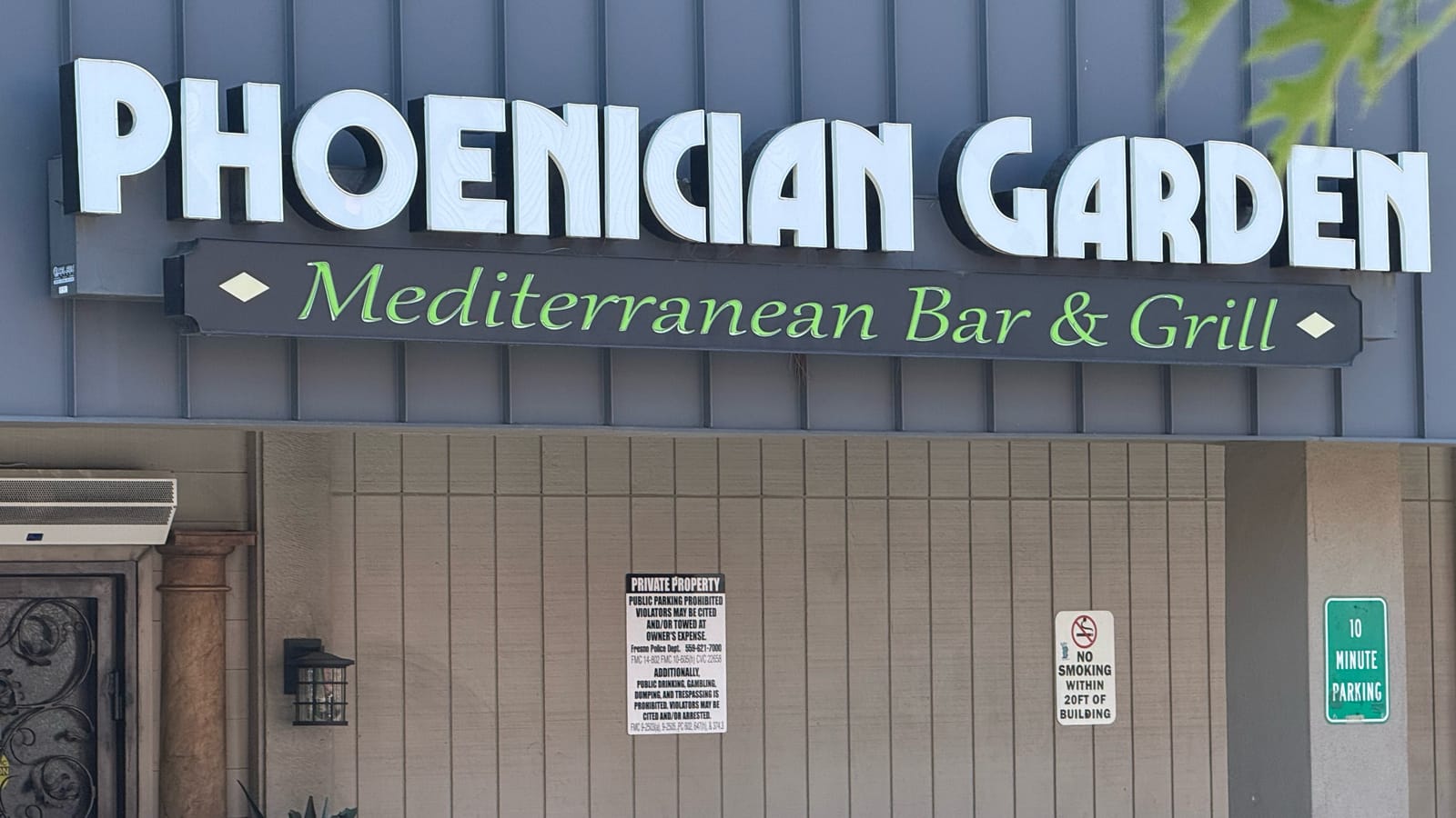 Phoenician Garden Mediterranean Bar and Grill storefront sign and entrance on E Herndon Ave in Fresno